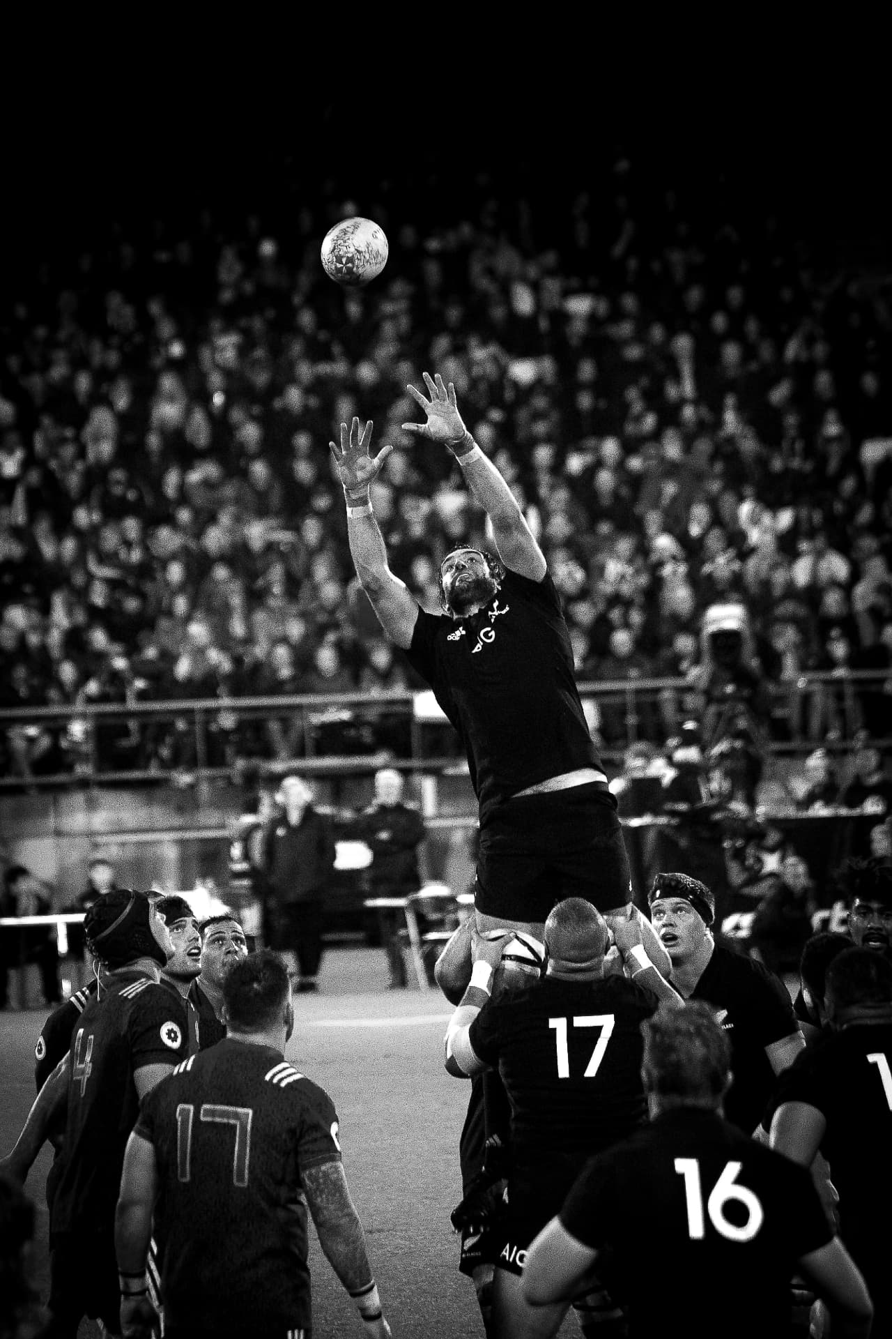 Rugby player lifting in a night-time lineout